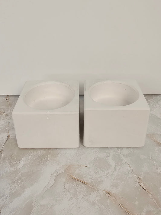 Two stone-look cube candle holders side by side on a marble surface, minimalist handmade decor by Gifts LA