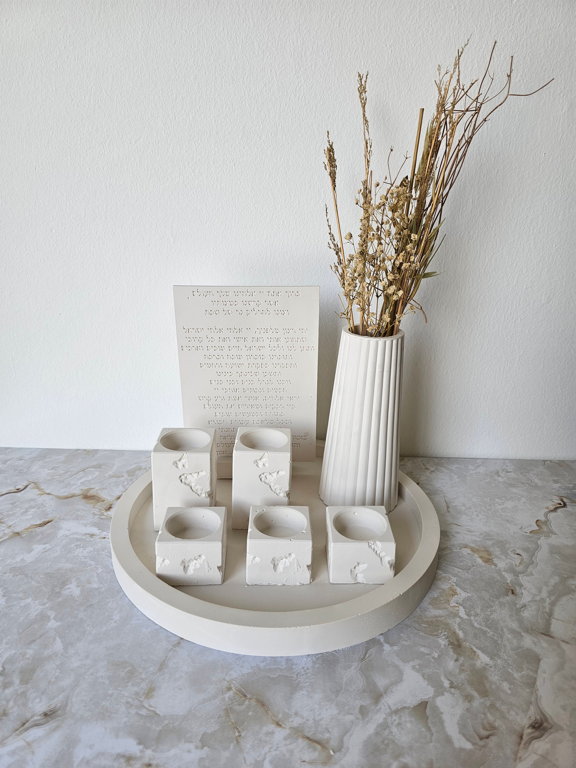 Terrazzo Decorative white sculpture with a vase holding dried branches on a marble surface Including the full shabbat candle lighting prayer 
