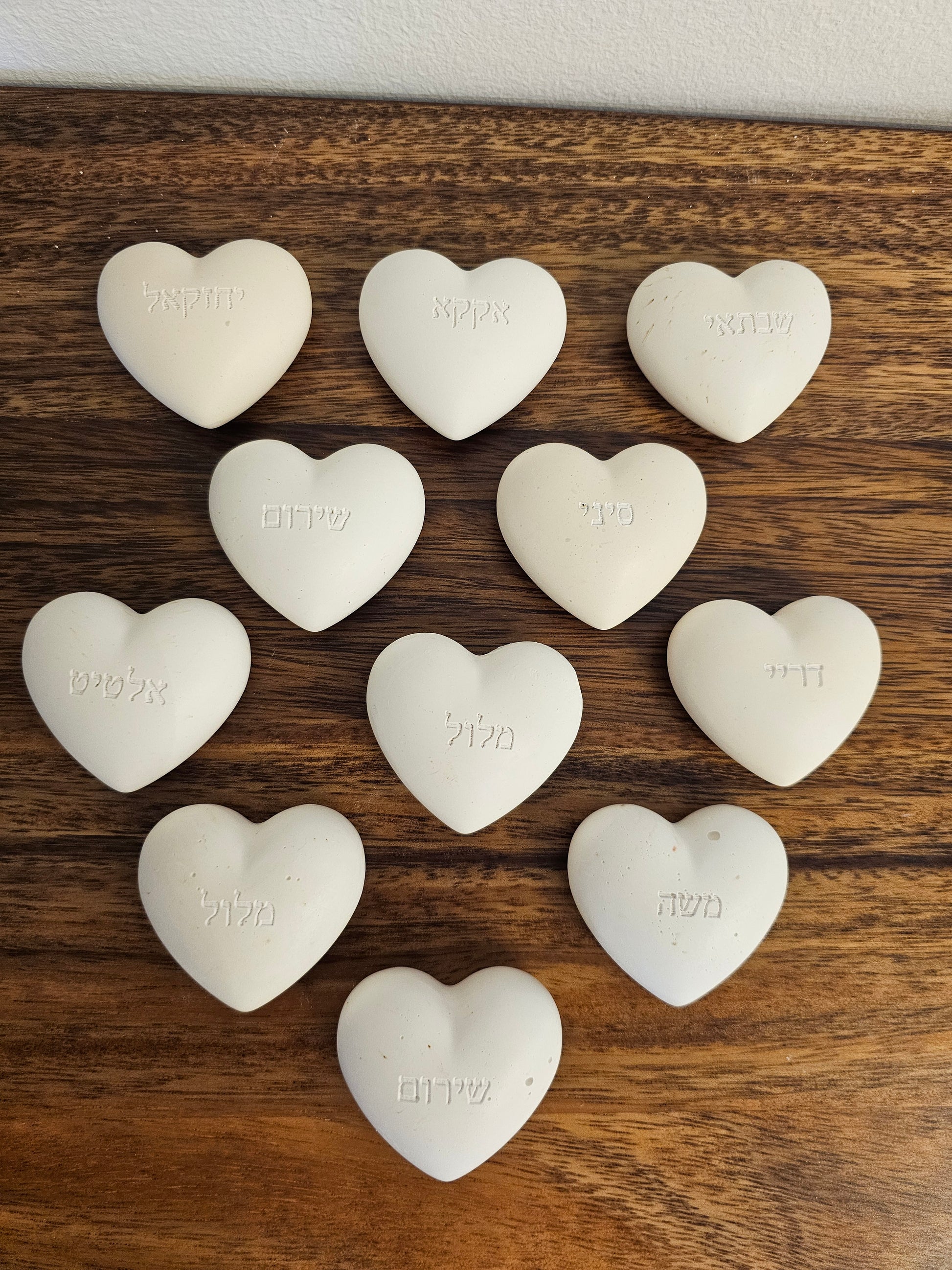 Personalized natural stone look heart-shaped plaques engraved with Hebrew family names — handmade Judaica home decor