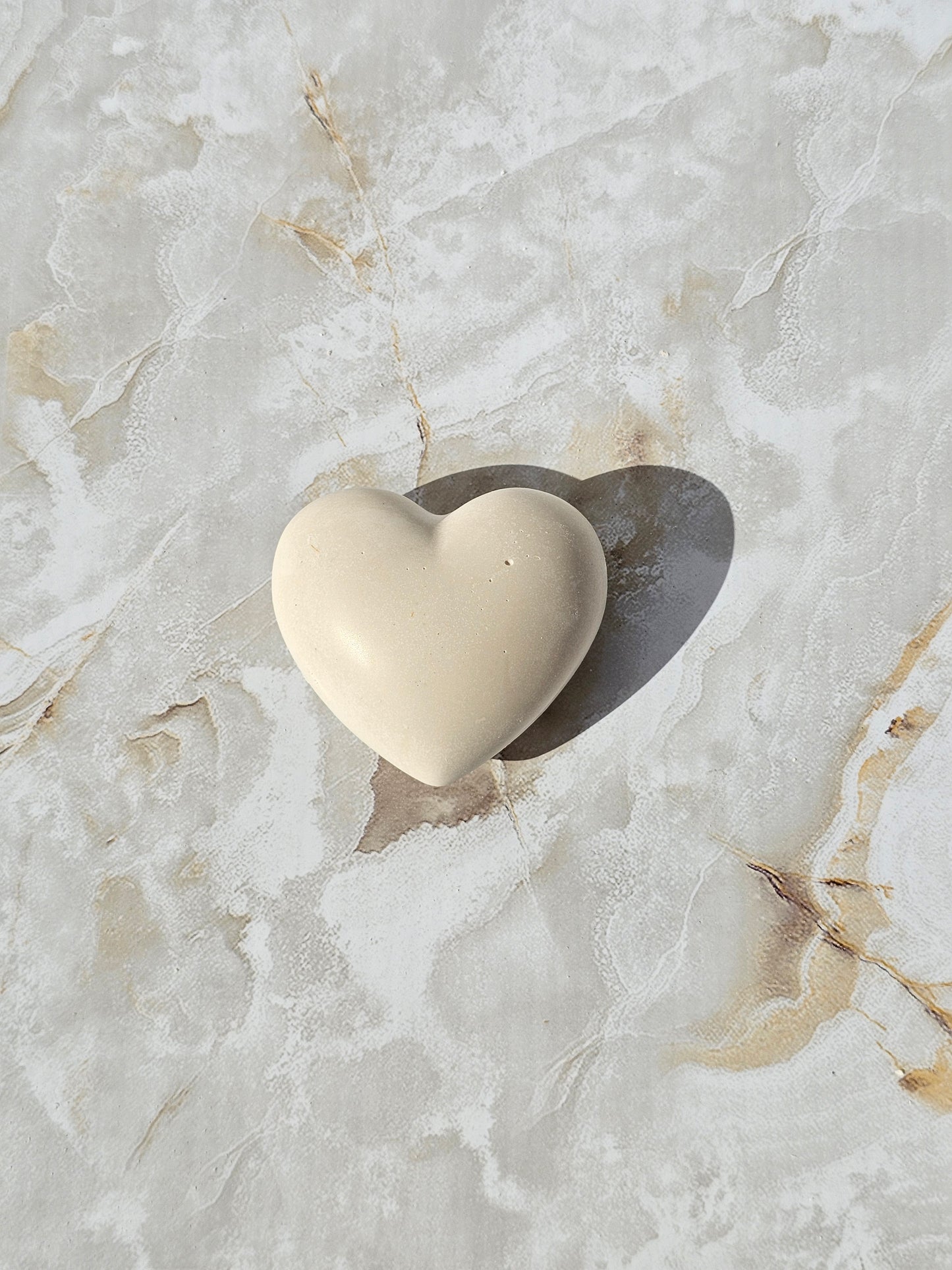 Two stone look Hebrew blessing hearts in different sizes on marble surface — handmade Judaica decor and Jewish gift